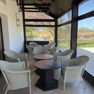 Terasa resortului cu fotolii si priveliste la apa